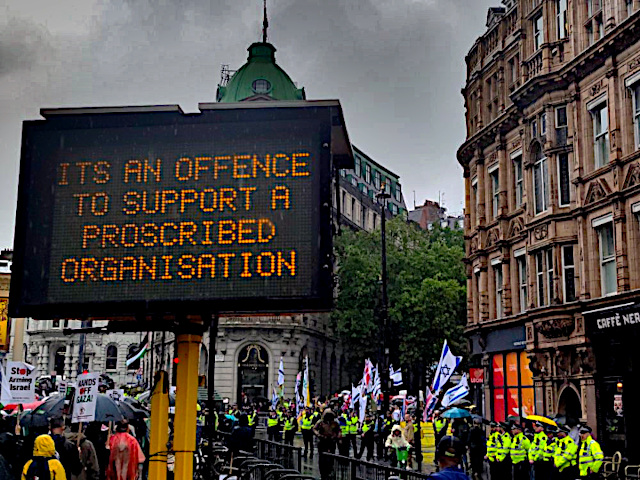 FRAW Gallery: ‘It is an offence to support a proscribed organization’ (police signs at a London protest, 2025)