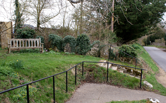 The bench by the steps to the church